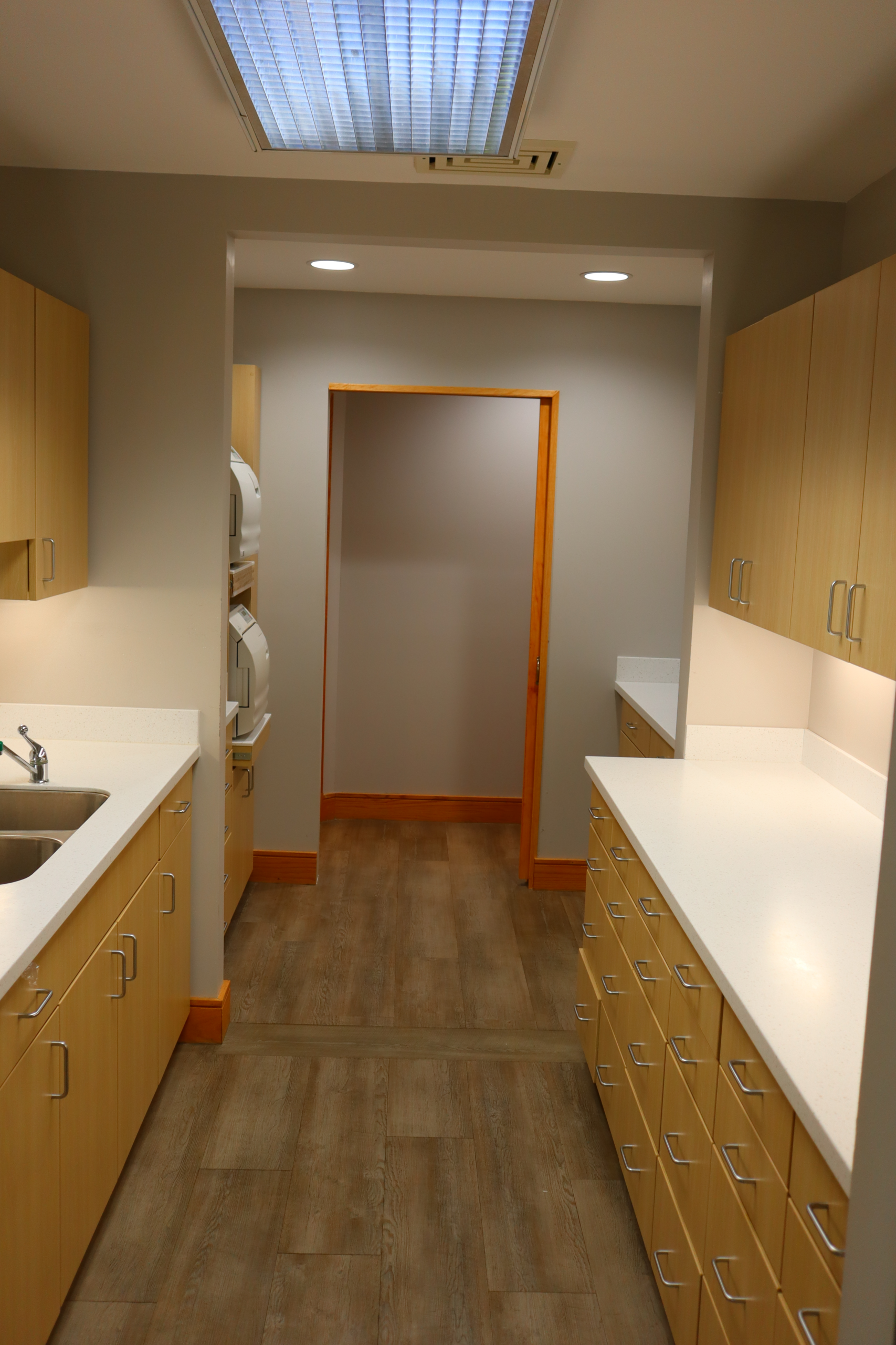 Bright hallway — warm lighting and open space at Sandu Family Dentistry